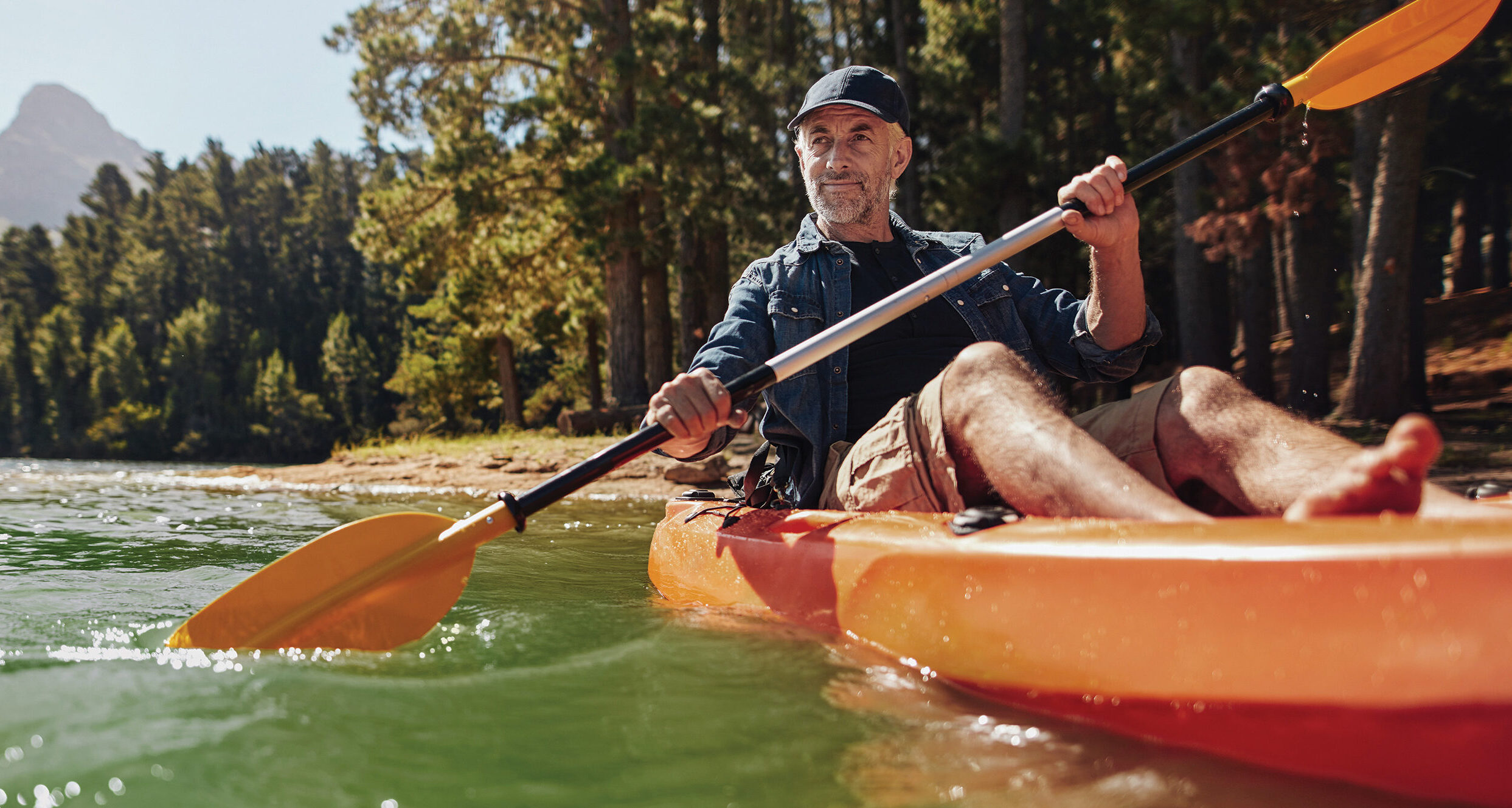 man kayaking in river