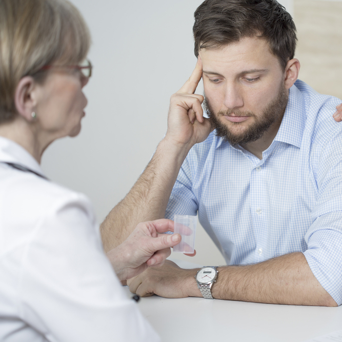 man speaking with a doctor.