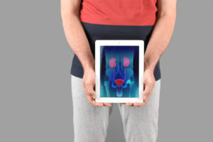 man holding ipad with a scan of organs
