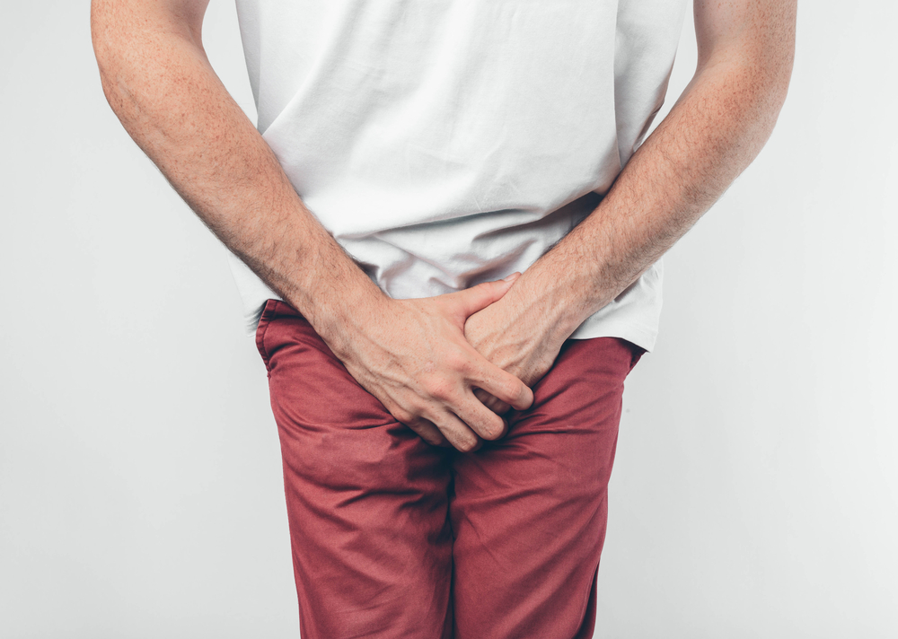 man holding his crotch because he needs to urinate