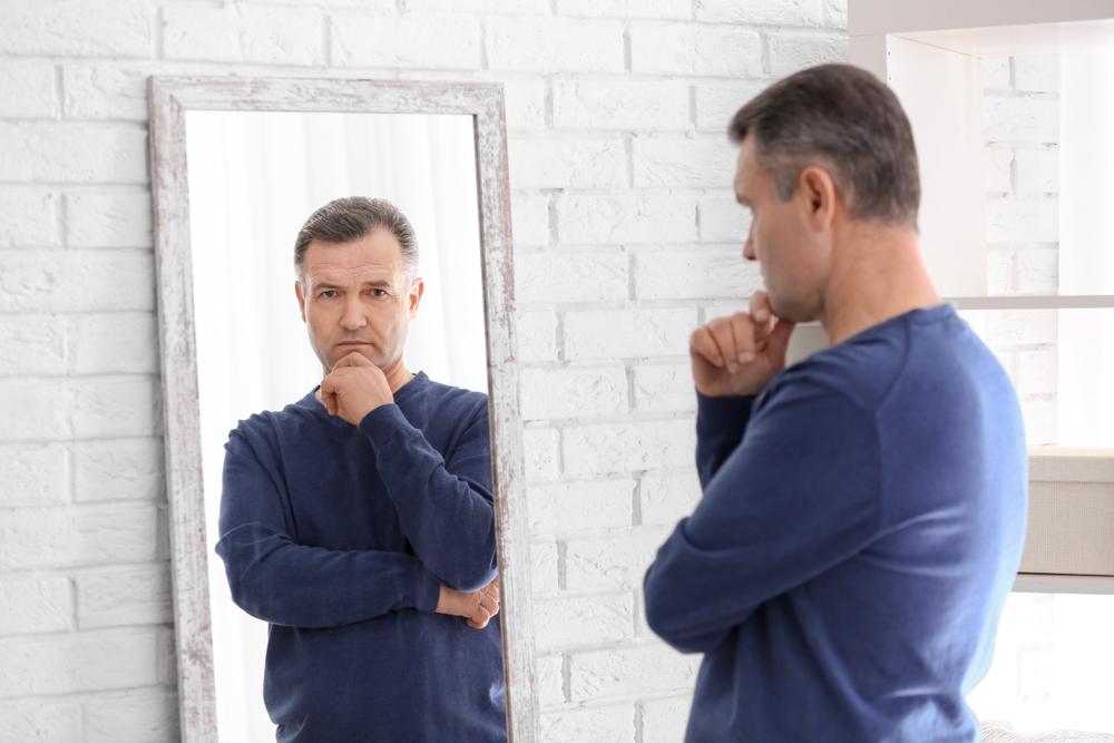 man looking at himself in the mirror