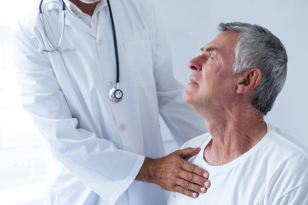 Doctor with hand on man's shoulder