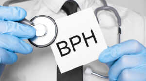 Doctor holding card with BPH on it. 