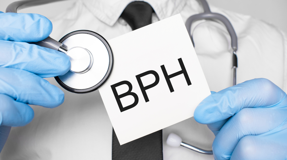 Doctor holding card with BPH on it.